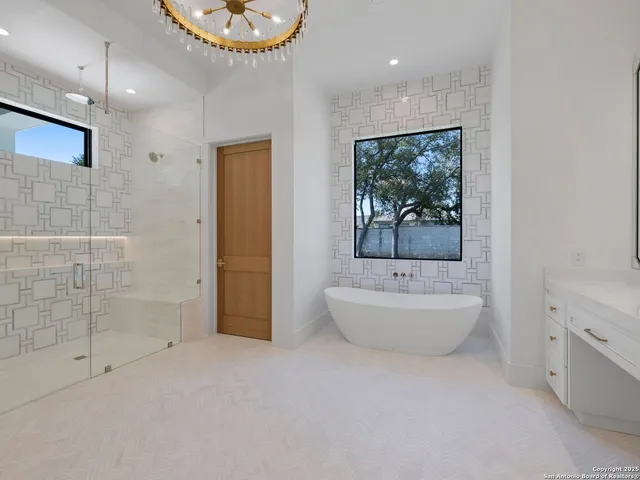 a bathroom with a double vanity sink a bathtub and a toilet