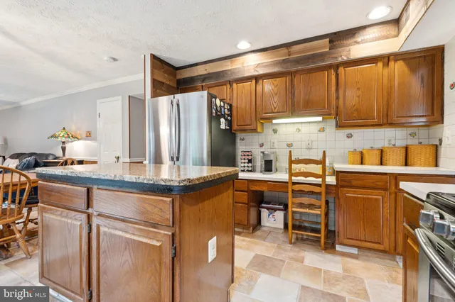 a kitchen with stainless steel appliances granite countertop a stove top oven a sink and cabinets