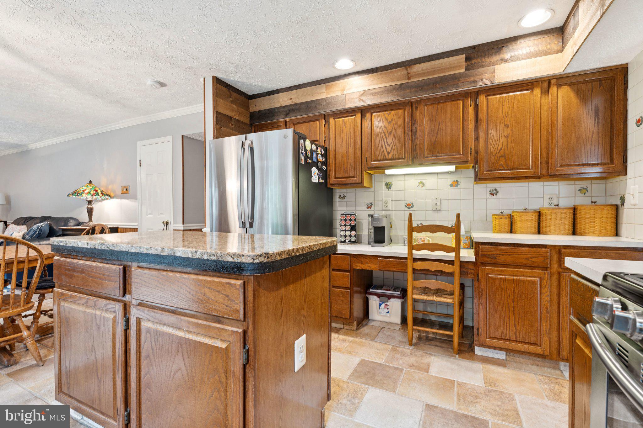 817 Peppard Drive Bel Air, MD 21014 - Photo 11 of 49 a kitchen with stainless steel appliances granite countertop a stove top oven a sink and cabinets