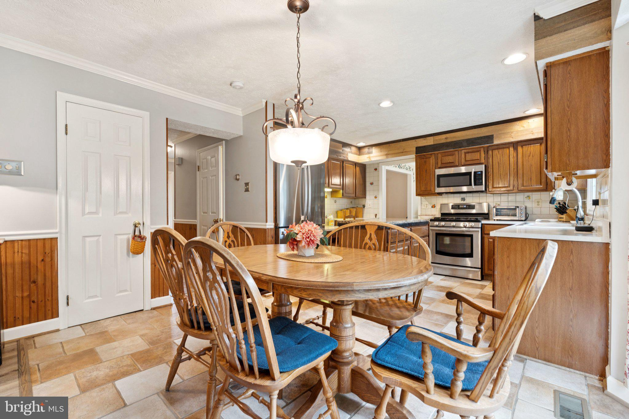 817 Peppard Drive Bel Air, MD 21014 - Photo 15 of 49 a dining room with a table chairs and a kitchen view
