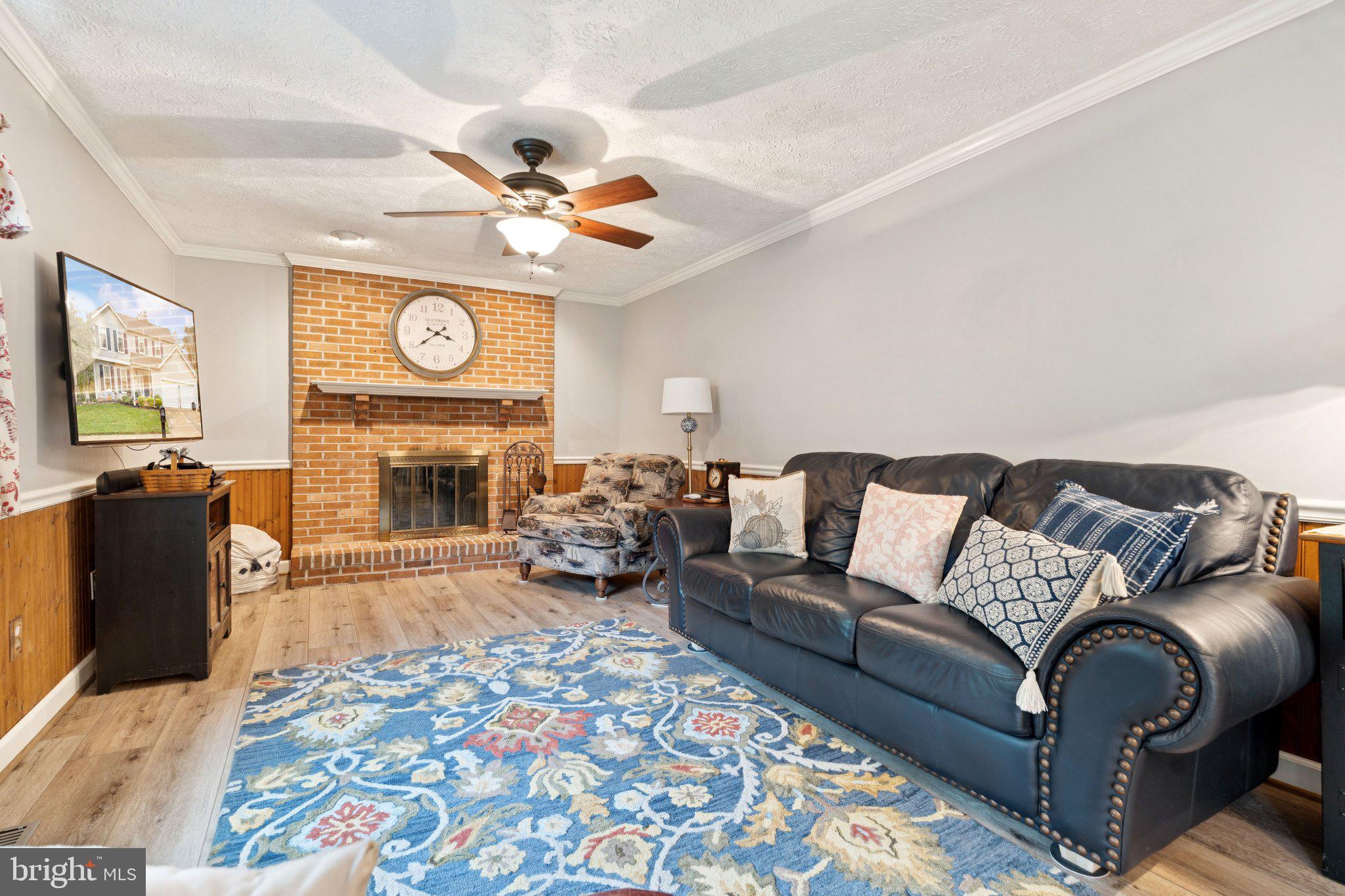 817 Peppard Drive Bel Air, MD 21014 - Photo 16 of 49 a living room with furniture a fireplace and a flat screen tv