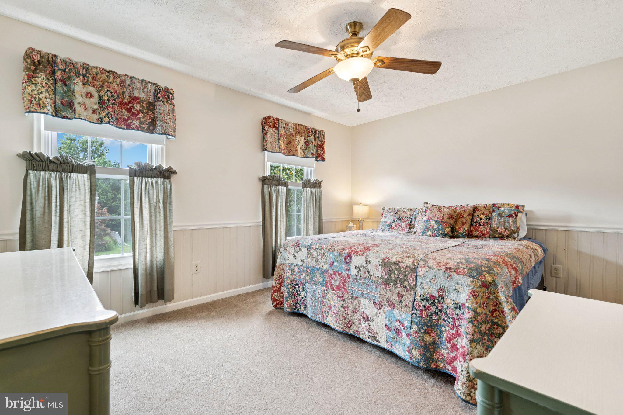 817 Peppard Drive Bel Air, MD 21014 - Photo 22 of 49 a bedroom with a large bed and a chandelier