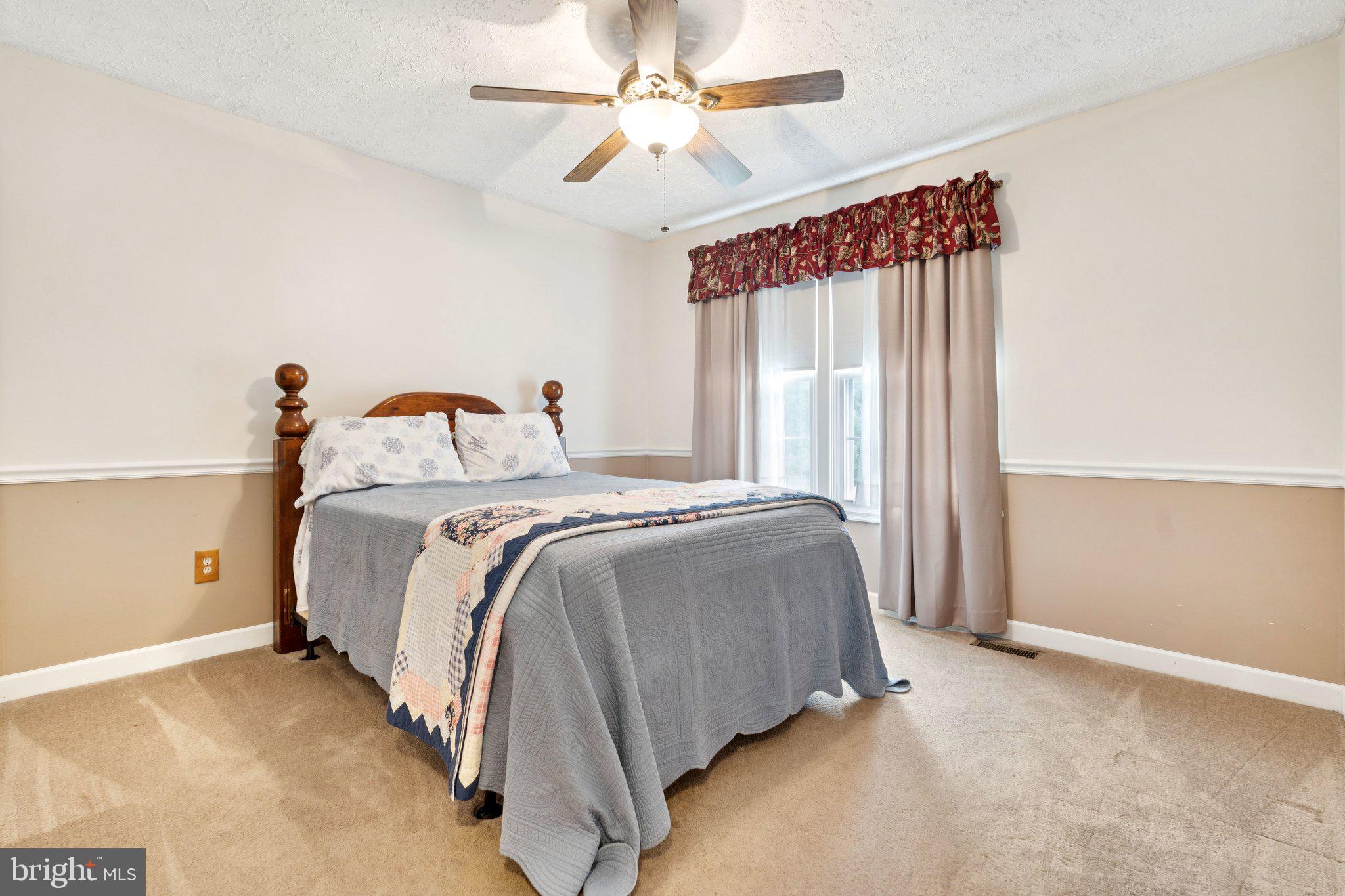 817 Peppard Drive Bel Air, MD 21014 - Photo 26 of 49 a bedroom with a bed and a chandelier