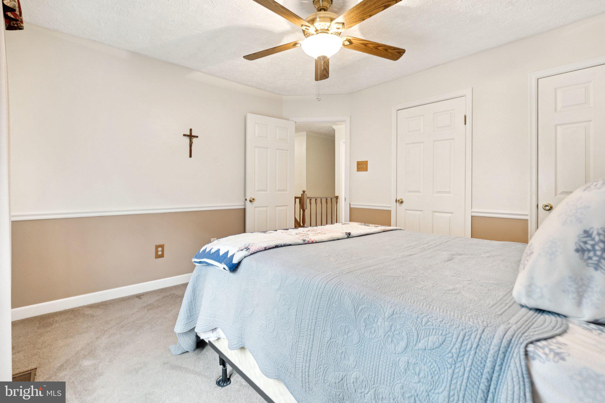 817 Peppard Drive Bel Air, MD 21014 - Photo 28 of 49 a bedroom with a bed and a chandelier