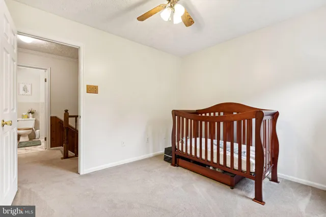 a view of a bedroom with furniture and a chandelier fan