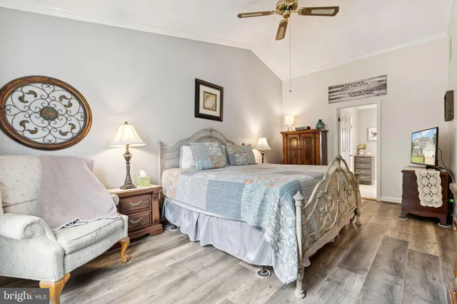 a bedroom with a bed and a large mirror on the dresser