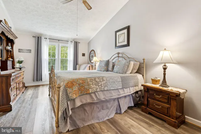 a living room with a bed furniture and a large window