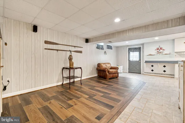 a view of a livingroom with wooden floor and furniture