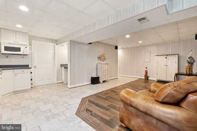 a kitchen with granite countertop a sink cabinets and stainless steel appliances