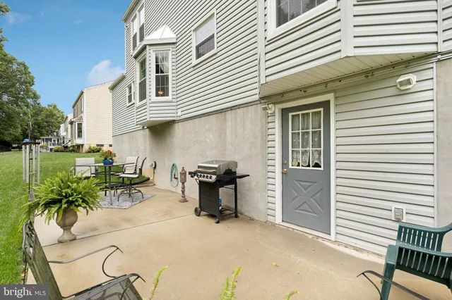 a front view of a house with a yard and potted plants