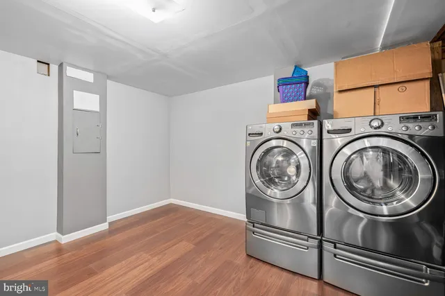 a view of washer and dryer with bathroom in the background