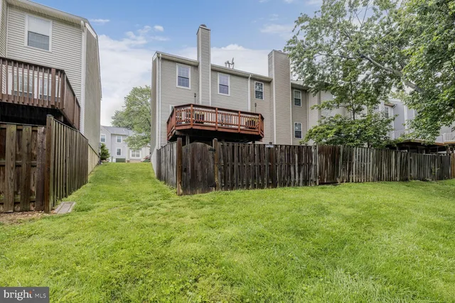 a view of a backyard with wooden fence