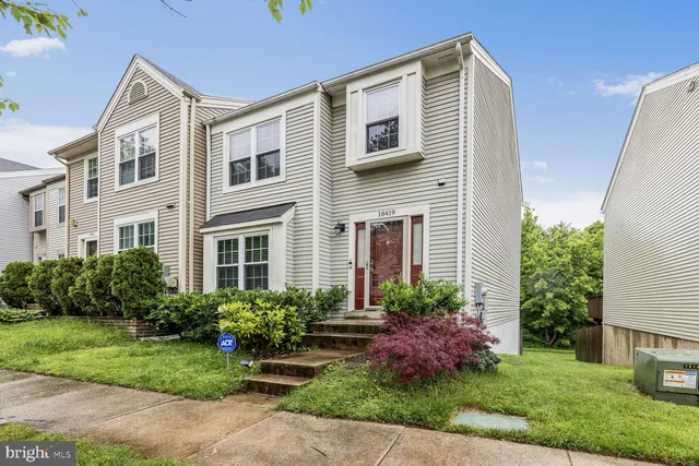 a front view of a house with garden and porch