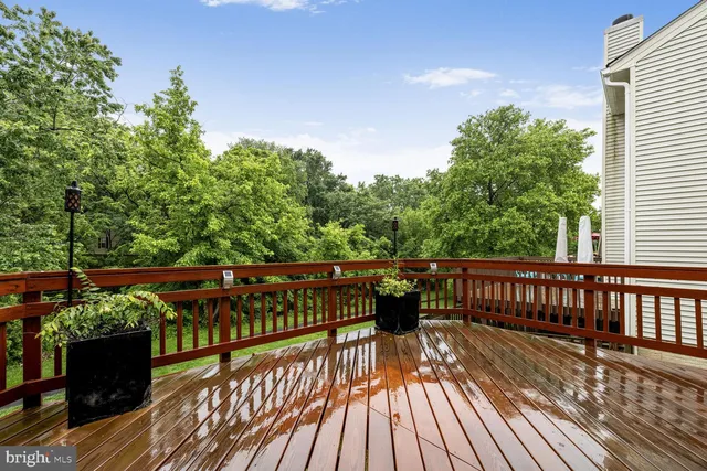 a view of balcony with wooden floor and outdoor seating