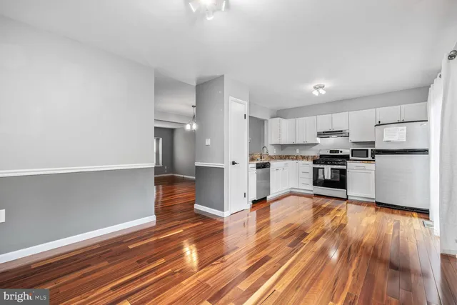 a view of kitchen view wooden floor and electronic appliances