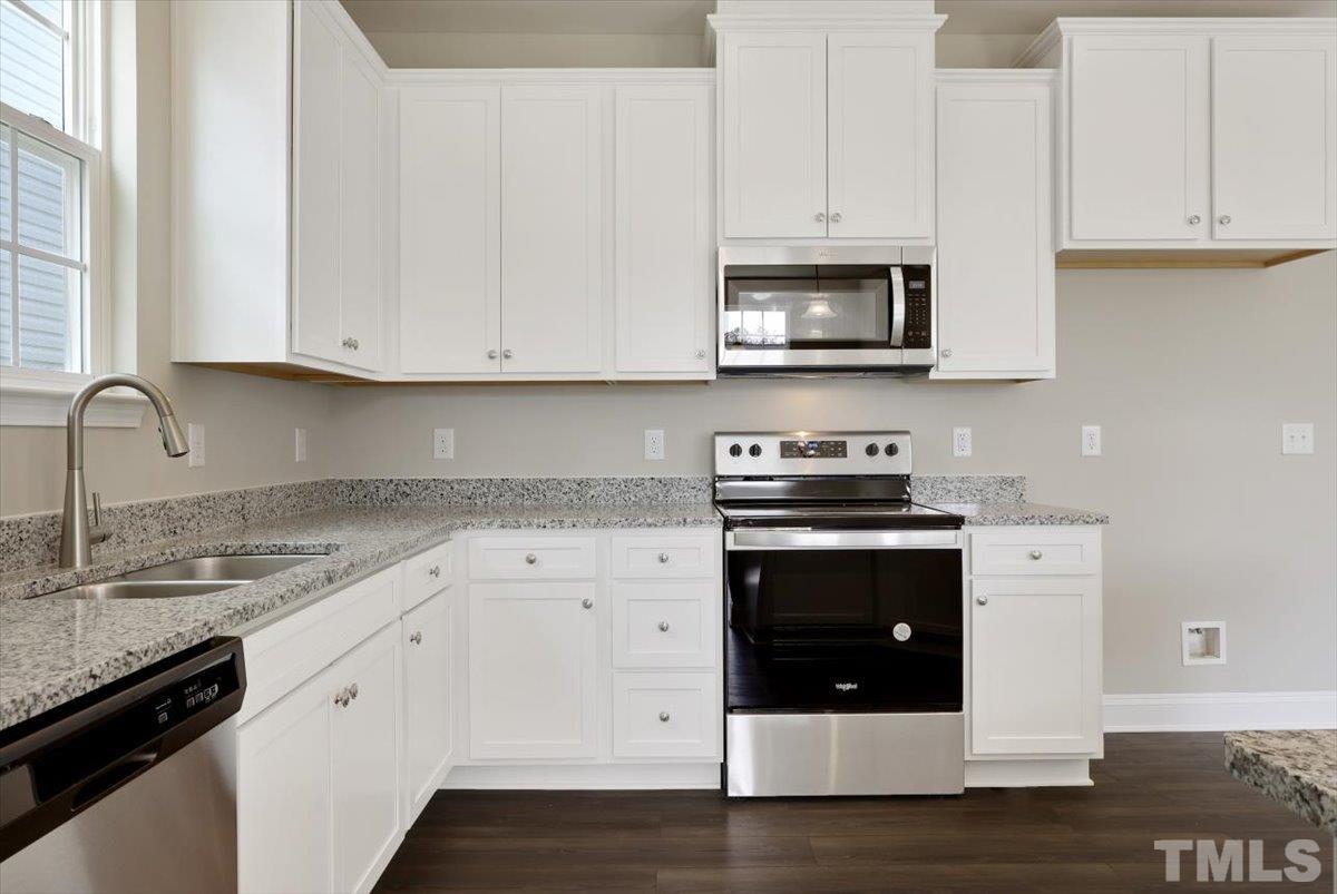 2215 Campbell Loop, Unit 49 Burlington, NC 27215 - Photo 13 of 48 a kitchen with stainless steel appliances granite countertop a stove and white cabinets