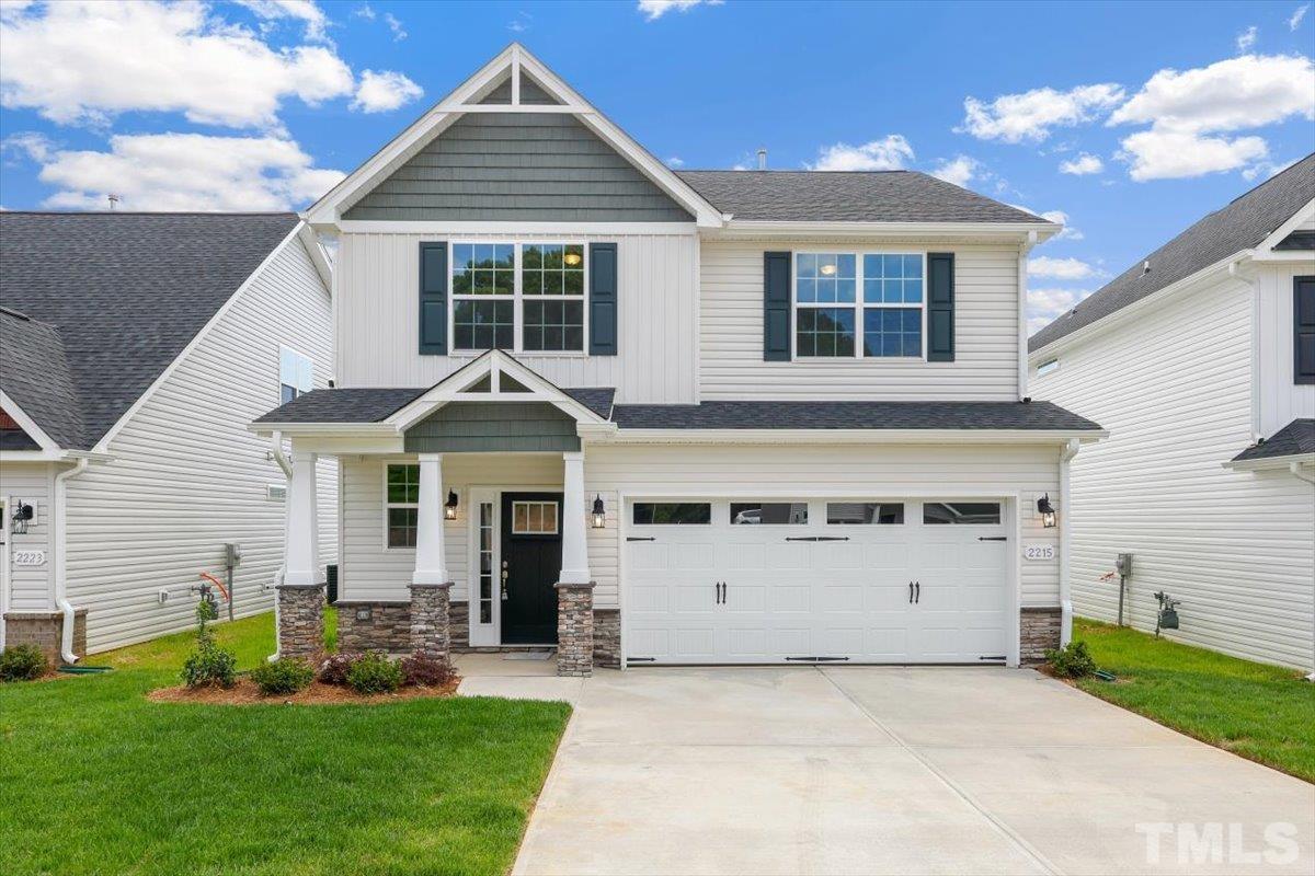 2215 Campbell Loop, Unit 49 Burlington, NC 27215 - Photo 2 of 48 a front view of a house with a yard and garage