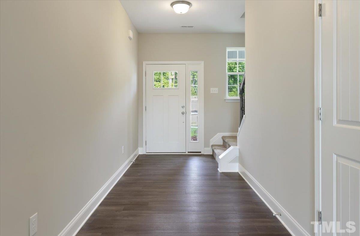 2215 Campbell Loop, Unit 49 Burlington, NC 27215 - Photo 5 of 48 a view of an empty room with wooden floor and a window