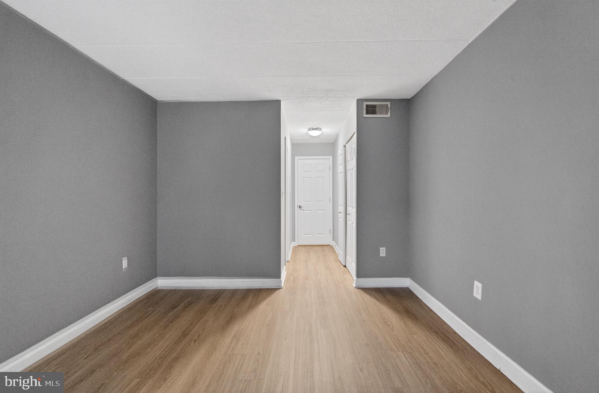3301 Hewitt Avenue, Unit 403 Silver Spring, MD 20906 - Photo 2 of 19 Spacious hallway with modern gray tones.