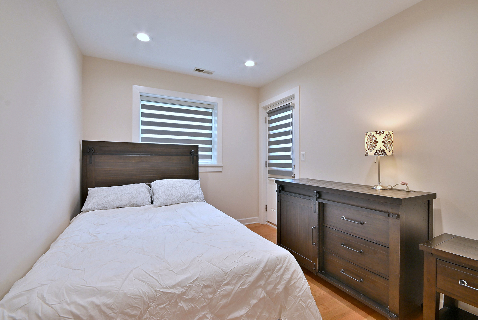 3045 North Paris Avenue, Unit 203 River Grove, IL 60171 - Photo 15 of 27 a bedroom with a bed and a window