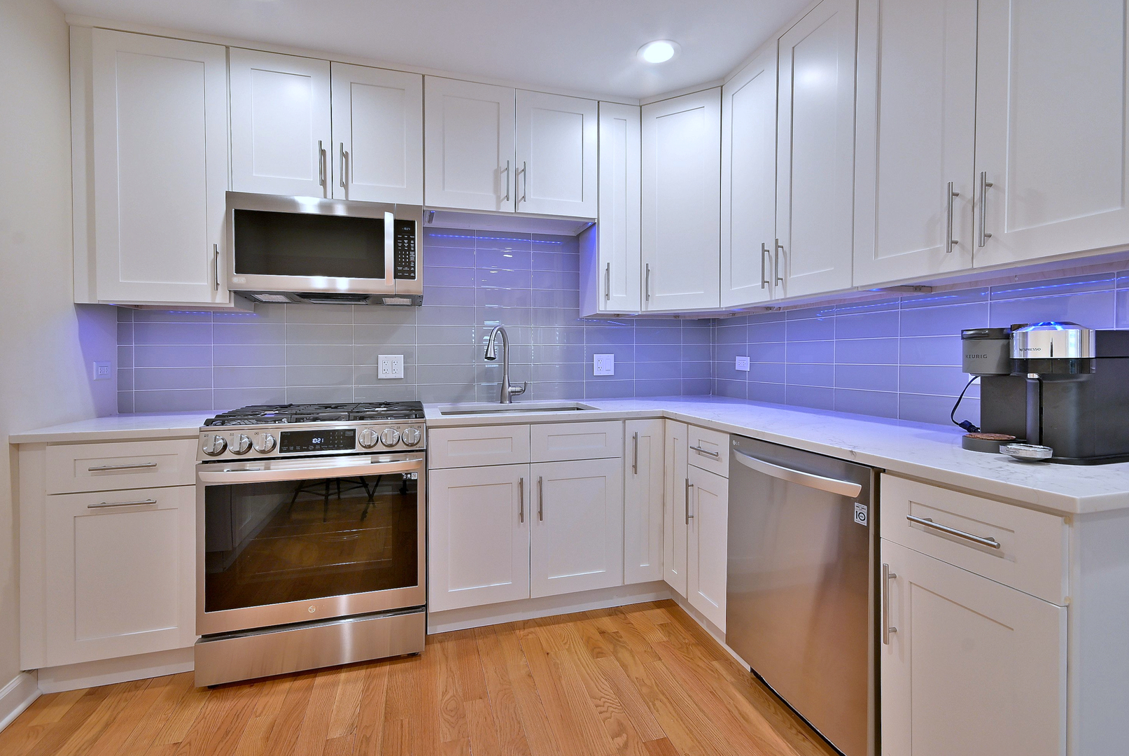 3045 North Paris Avenue, Unit 203 River Grove, IL 60171 - Photo 9 of 27 a kitchen with stainless steel appliances granite countertop a sink stove and microwave