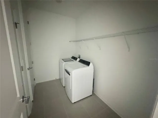 a utility room with a sink dryer and washer