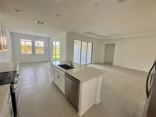 a kitchen with stainless steel appliances a sink and a stove