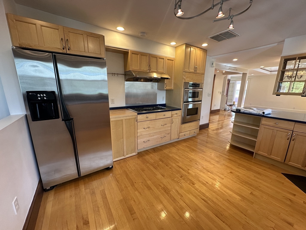 17 Herbert Road, Unit 1 Arlington, MA 02474 - Photo 4 of 26 a kitchen with stainless steel appliances granite countertop a refrigerator a sink and a stove