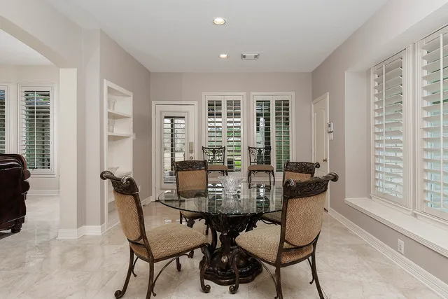 a view of a dining room with furniture and windows