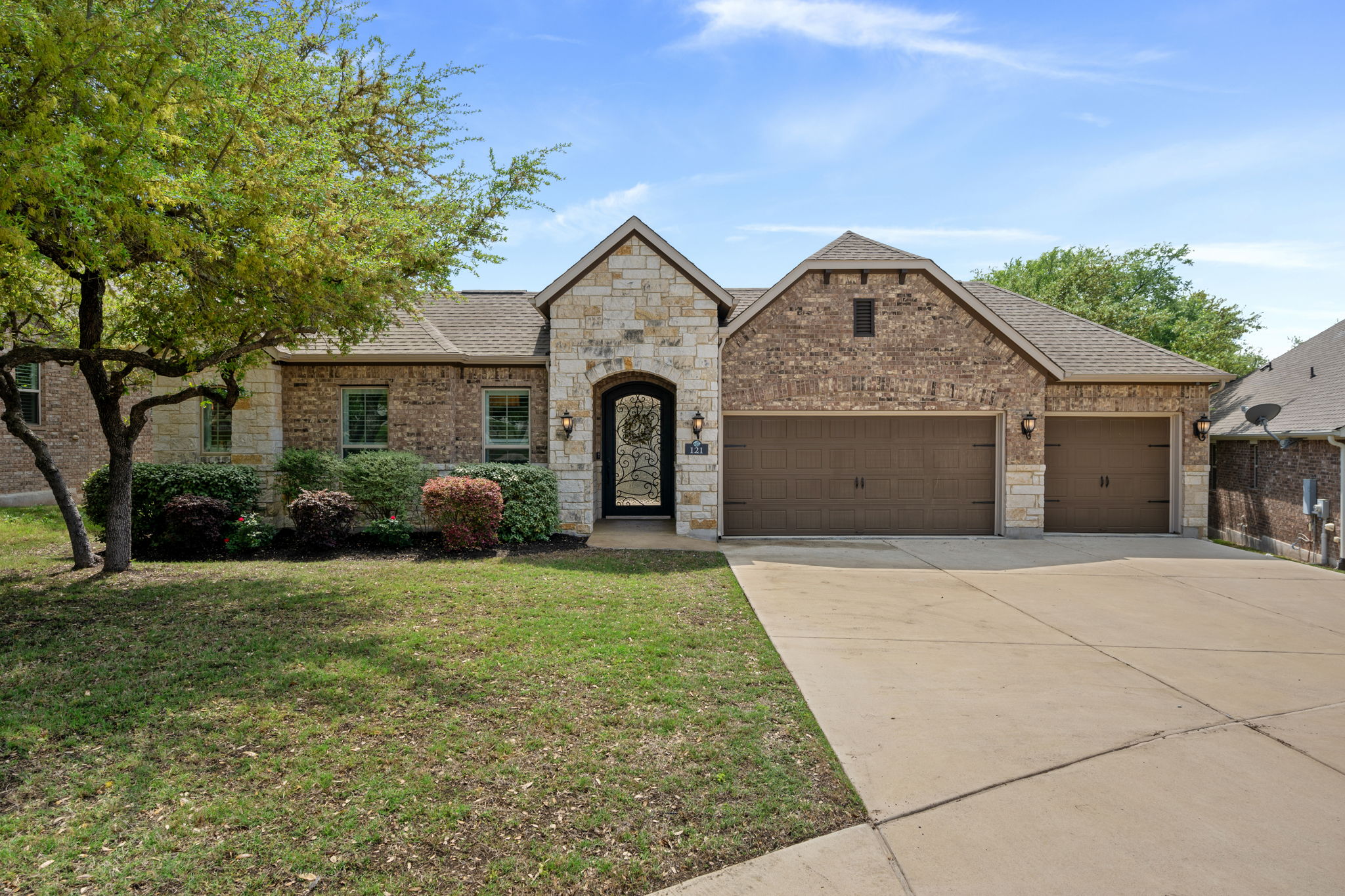 a front view of a house with a yard and garage