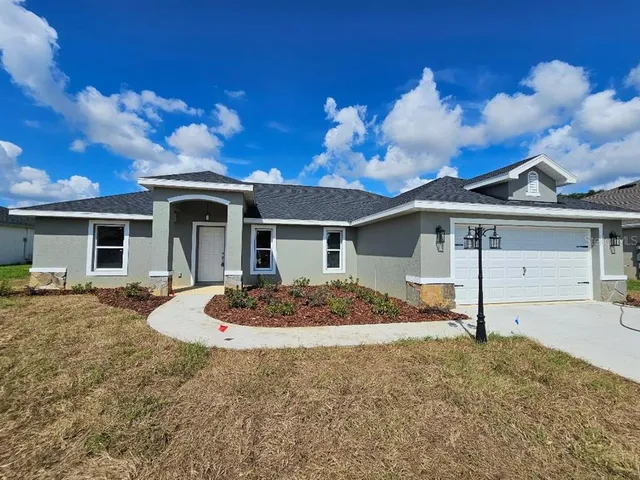 a view of a house with backyard and porch