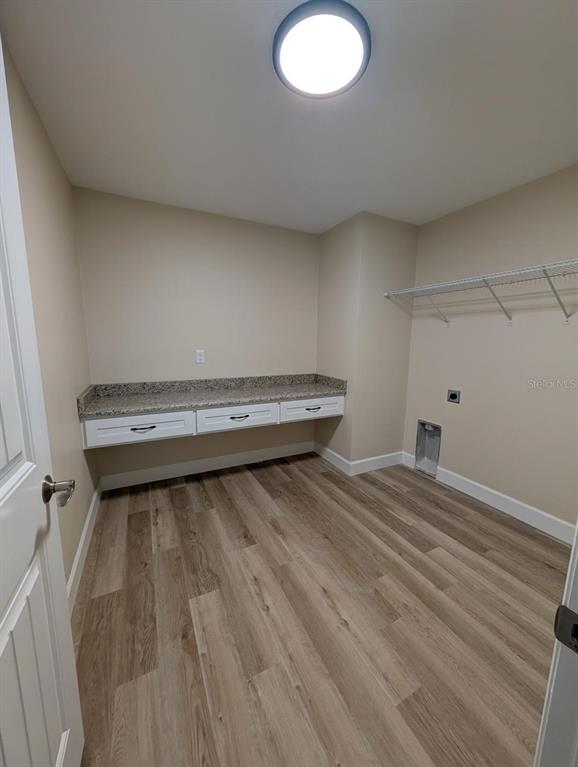 5441 Chestnut Ridge Road Dade City, FL 33523 - Photo 11 of 27 a view of a room with wooden floors and led lights