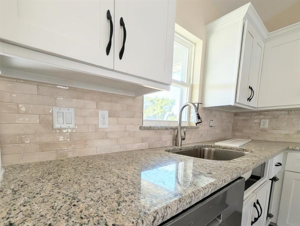 5441 Chestnut Ridge Road Dade City, FL 33523 - Photo 14 of 23 a kitchen with kitchen island a sink appliances and a counter top