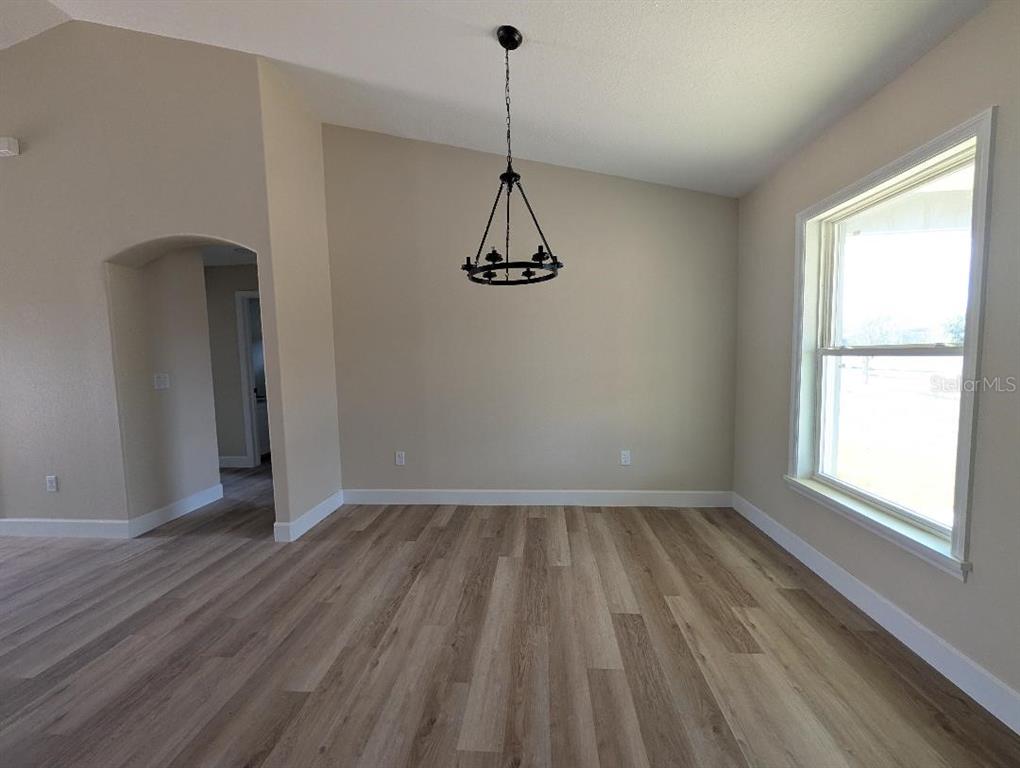 5441 Chestnut Ridge Road Dade City, FL 33523 - Photo 19 of 27 a view of empty room with wooden floor and fan