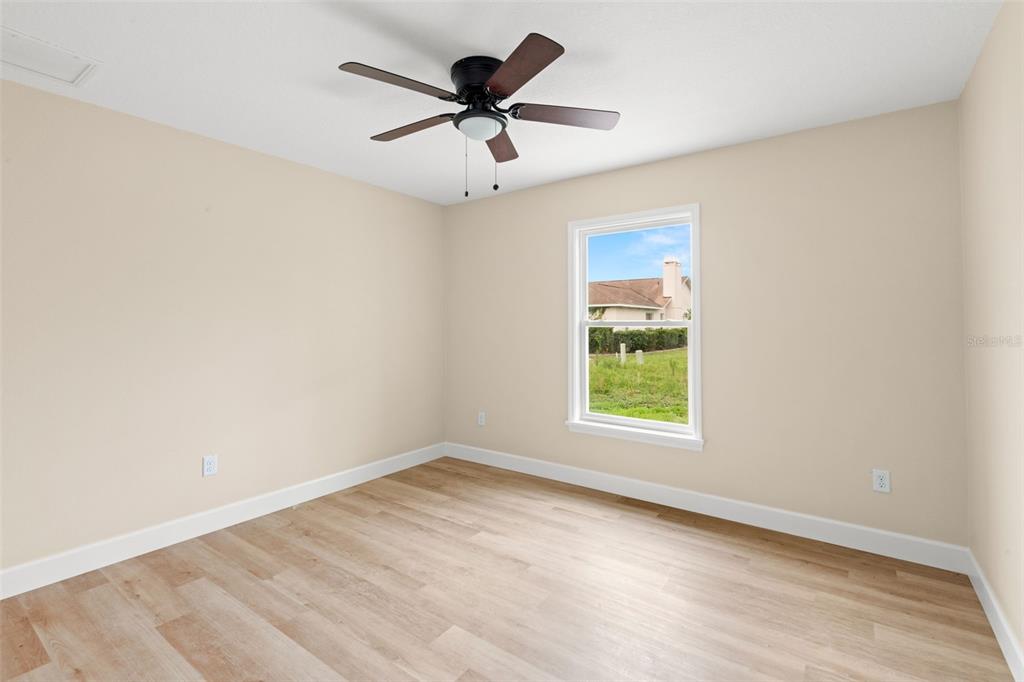 5441 Chestnut Ridge Road Dade City, FL 33523 - Photo 22 of 23 an empty room with a window and a fan