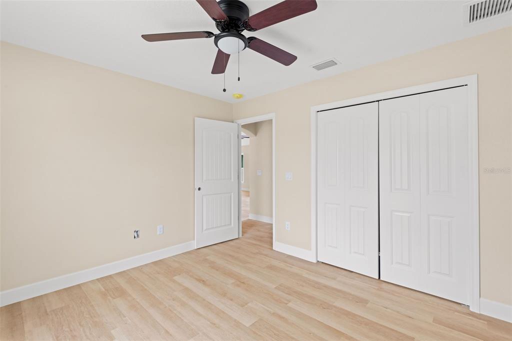 5441 Chestnut Ridge Road Dade City, FL 33523 - Photo 25 of 27 an empty room with a ceiling fan and carpet