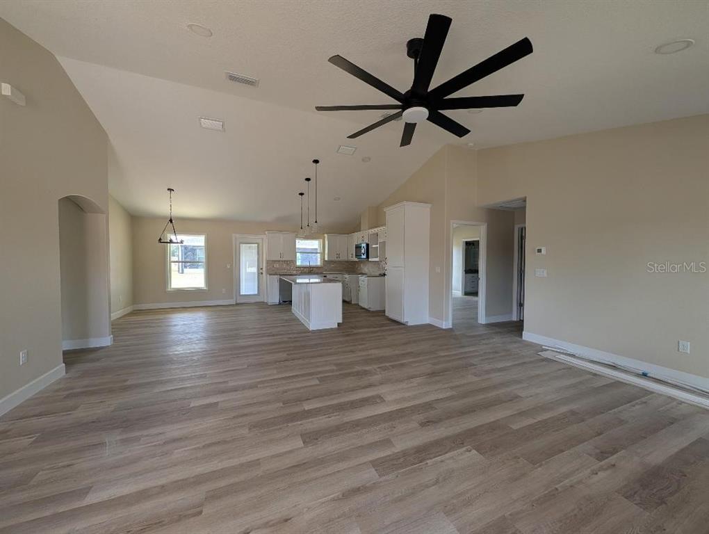 5441 Chestnut Ridge Road Dade City, FL 33523 - Photo 3 of 23 a view of empty room with wooden floor and window