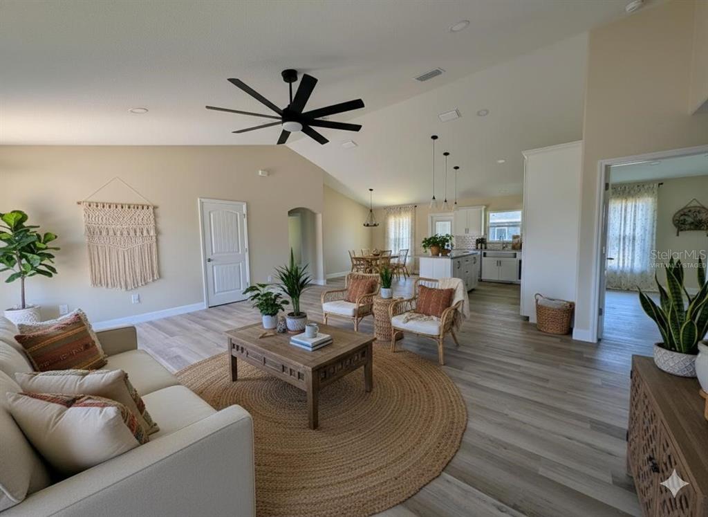 5441 Chestnut Ridge Road Dade City, FL 33523 - Photo 3 of 27 a living room with furniture and a wooden floor