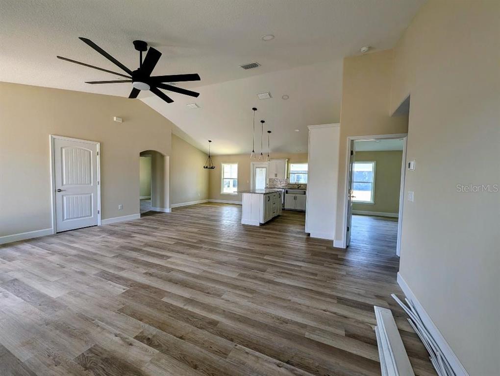 5441 Chestnut Ridge Road Dade City, FL 33523 - Photo 5 of 23 a view of a livingroom with a ceiling fan wooden floor and window