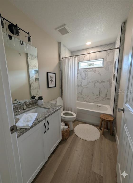 5441 Chestnut Ridge Road Dade City, FL 33523 - Photo 9 of 27 a bathroom with a granite countertop sink toilet and shower