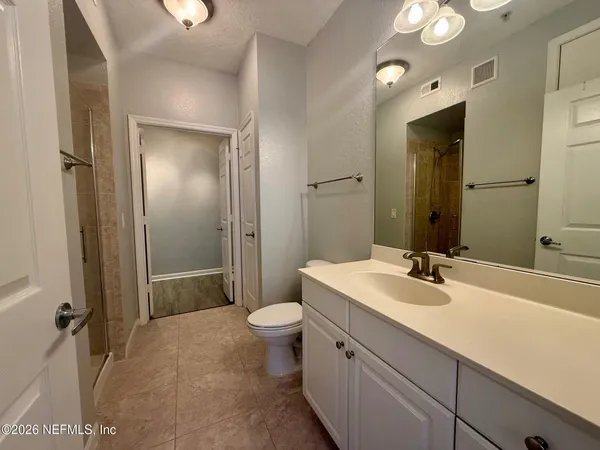 a bathroom with a sink and a mirror with toilet