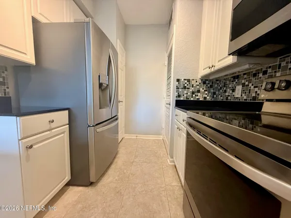 a kitchen with stainless steel appliances granite countertop a stove and a refrigerator