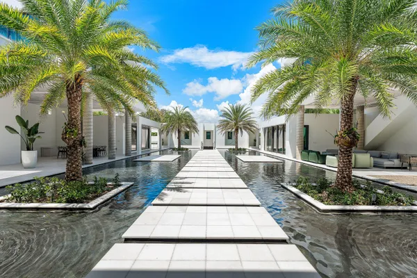 a front view of a house with lots of trees