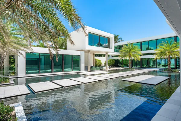 a view of a house with backyard patio and swimming pool