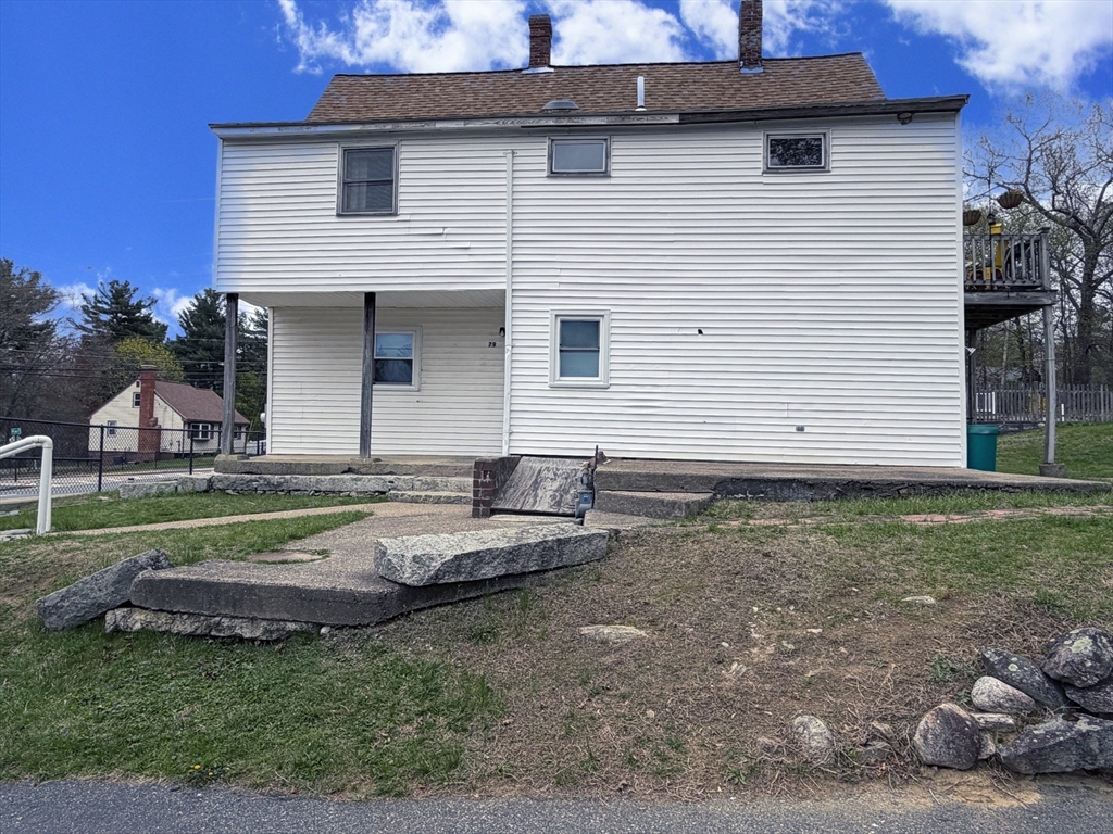79 North Main Street, Unit A Bellingham, MA 02019 - Photo 19 of 22 a view of a house with a yard and sitting area