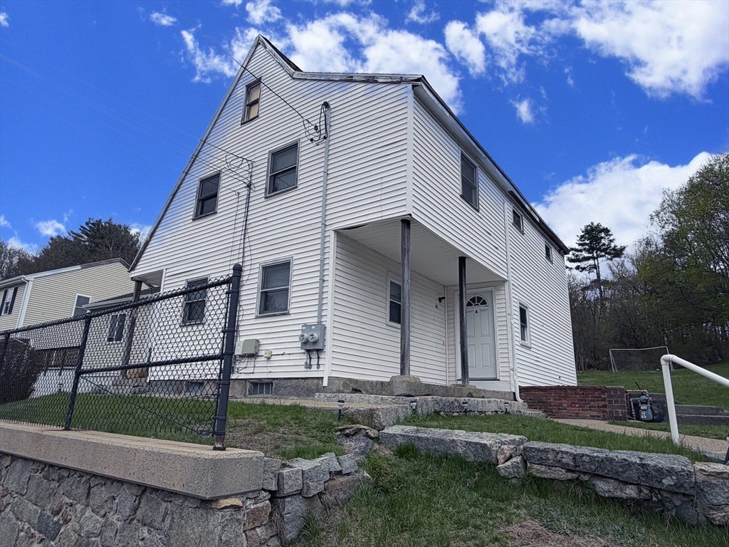 79 North Main Street, Unit A Bellingham, MA 02019 - Photo 2 of 22 a view of a white house with a yard and plants