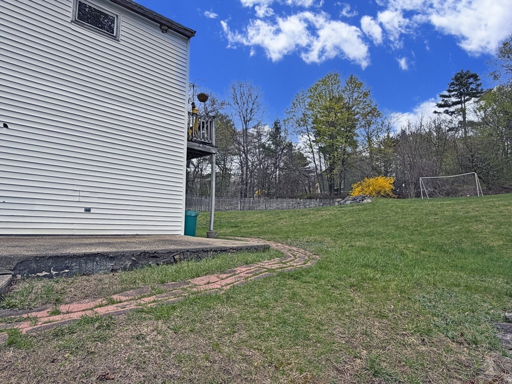 79 North Main Street, Unit A Bellingham, MA 02019 - Photo 21 of 22 a view of a backyard with plants and large tree
