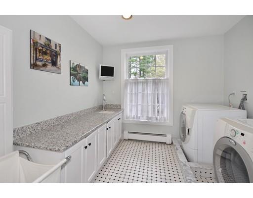 336 Lexington Road Concord, MA 01742 - Photo 22 of 29 a bathroom with a granite countertop sink a large mirror and a shower