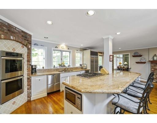 336 Lexington Road Concord, MA 01742 - Photo 10 of 29 a kitchen with stainless steel appliances granite countertop a stove and a sink