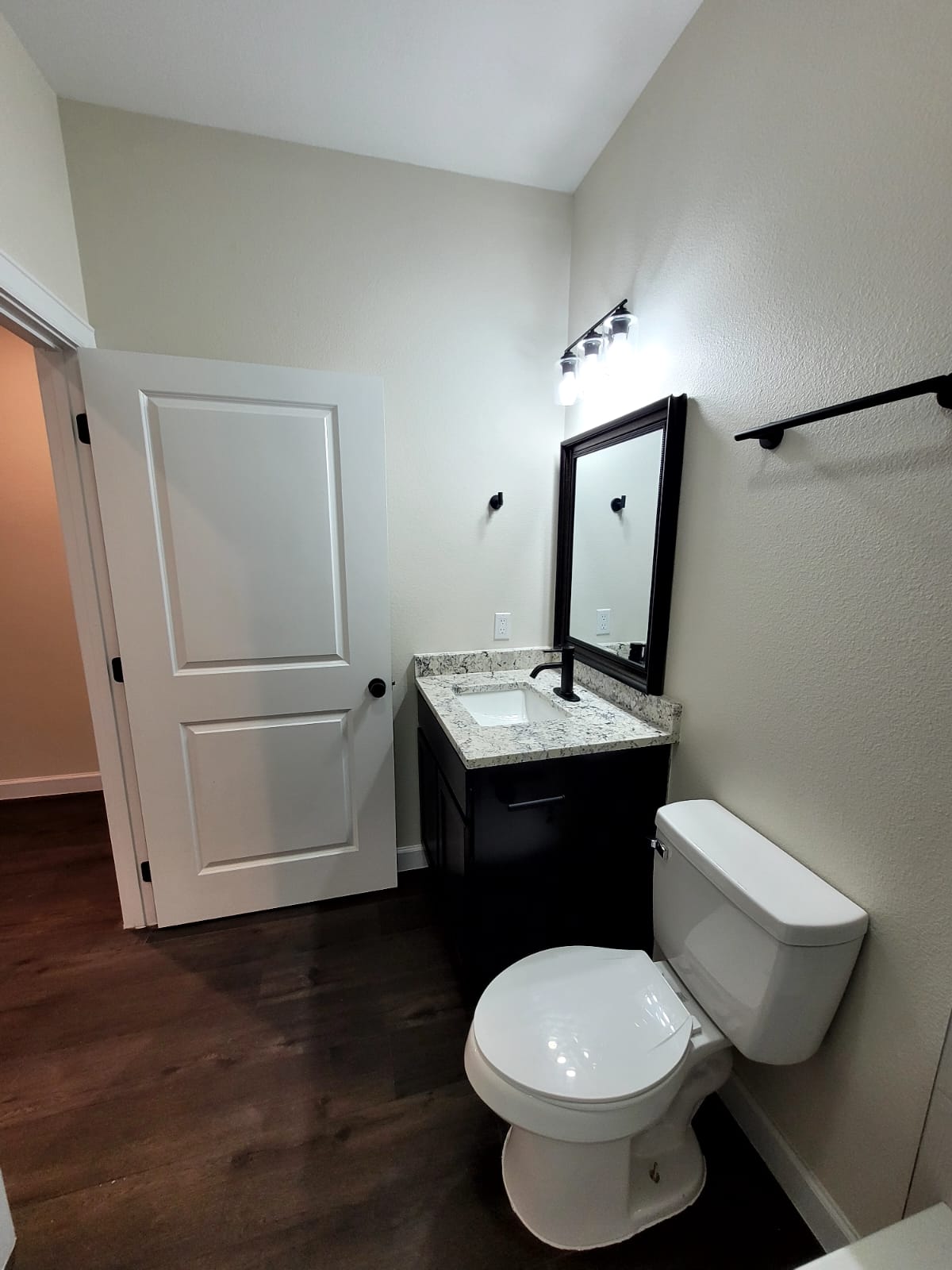 750 South Main Street Lockhart, TX 78644 - Photo 12 of 31 Bathroom with vanity and dark wood-style flooring